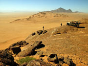A game drive in the desert ends with a view over a stunning vista in Namibia.