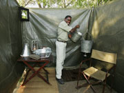 The staff fill the shared bucket showers in Adventurer mobile safari camps with hot water on demand.
