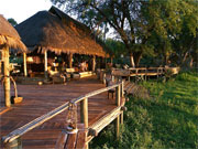 The morning sun paints a rosy glow on the deck of the lounge at Mombo Camp in the Okavango Delta, Botswana.
