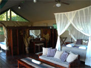 A four-poster bed swathed in mosquito netting is the centrepiece of a superior tent at Chiawa Camp, Lower Zambezi, Zambia.